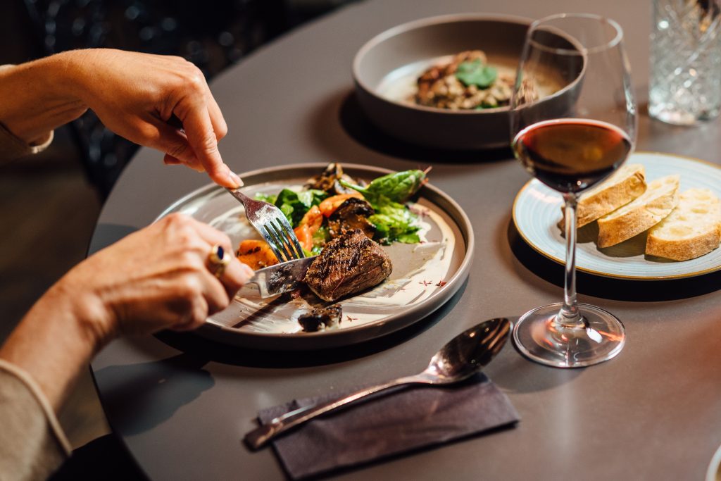 Elegant,Restaurant,Dining,Scene,Featuring,Ostrich,Fillet,With,Grilled,Vegetables,
